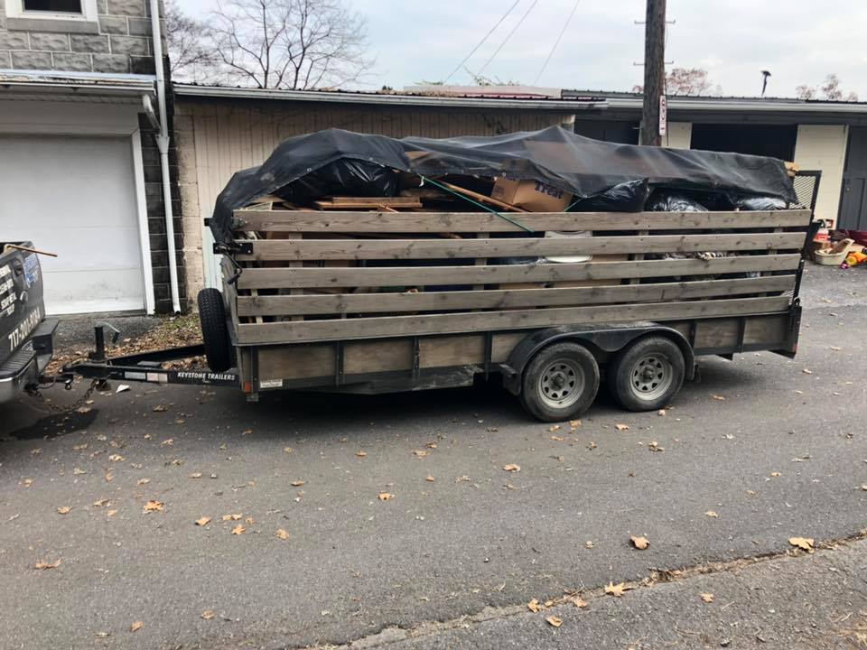 loaded utility trailer with junk removal items